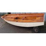 A 10ft 10'' X 4ft 7'' ROWING BOAT WITH TRAILER, DAGGER BOARD, TWO OARS, MAST & BEAM