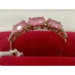 A PINK THREE STONE SET IN 9ct