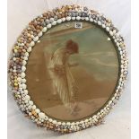 VICTORIAN SHELL DECORATED FRAME WITH HAND TINTED COLOUR PRINT OF A LADY ON A BEACH HOLDING A SEA