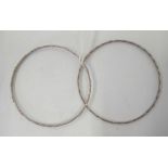 A PAIR OF CHASED WHITE METAL BANGLES