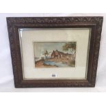 19THC WATERCOLOUR OF FIGURES ON A BRIDGE BESIDE A FARMSTEAD WITHIN A CARVED WOOD FRAME