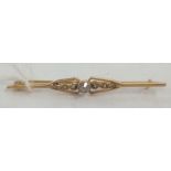 AN ANTIQUE 9ct BAR BROOCH SET WITH WHITE STONE & 6 PEARLS