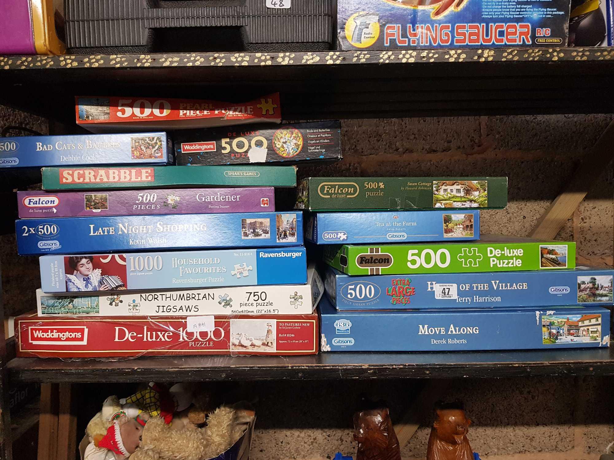 SHELF OF VARIOUS JIGSAW PUZZLES