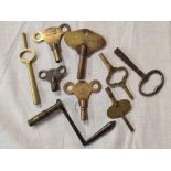 BAG OF 8 BRASS AND OTHER CLOCK KEYS & A LONG CASE CLOCK WINDER