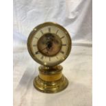 SMALL BRASS TABLE CLOCK ON PEDESTAL