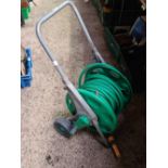 GREEN GARDEN HOSE ON CARRIER