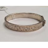 A SILVER HINGED BRACELET ENGRAVED WITH LEAF MOTIFS