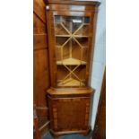 MODERN REPRODUCTION YEW WOOD CORNER DISPLAY UNIT WITH CUPBOARD & PART GLAZED TO FRONT