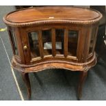 SMALL KIDNEY SHAPED MAHOGANY GLASS FRONTED CUPBOARD, WITH BEVELLED CLASP (NICELY CARVED)