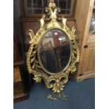 GILT FRAMED OVAL WALL MIRROR WITH BEVELLED EDGE, SOME PIECES LOOSE