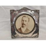 A SILVER ART NOUVEAU EASEL PHOTO FRAME H/M B'HAM 1912 WITH INSCRIPTION TO REAR OF PHOTO. SOME LOSS