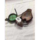 AN ARMY STYLE PRISMATIC MARCHING COMPASS WITH LEATHER CARRY CASE