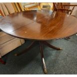 MAHOGANY EXTENDING CIRCULAR DINING TABLE ON PEDESTAL LEGS