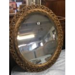 LARGE HEAVILY GILT FRAMED BEVELLED EDGE OVAL MIRROR, 2ft 4'' WIDE