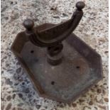 AN EARLY CAST IRON BOOT SCRAPER