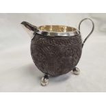 A CARVED COCONUT JUG WITH SILVER INTERIOR & LEGS