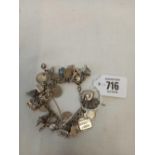 A HEAVY SILVER CHARM BRACELET