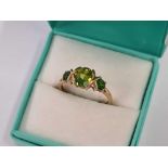 9ct GOLD RING WITH 3 GREEN STONES, SIZE 'R'. 2.