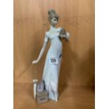 TALL FIGURINE OF A LADY WITH BOX