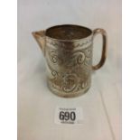 AN EDWARDIAN SILVER EMBOSSED CREAM JUG,