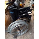 AN INVACARE ACTION THREE FOLDING WHEEL CHAIR WITH TWO SPARE WHEELS