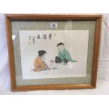 HAND-COLOURED JAPANESE PRINT OF TWO SEATED CHILDREN PLAYING A GAME WITH BEAD COUNTERS.