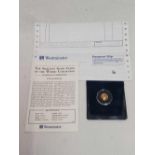 A SMALL 24ct GOLD PROOF COIN WITH C.O.