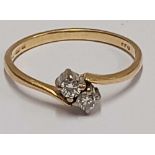 A 2 STONE DIAMOND CROSS OVER RING SET IN 18ct GOLD,