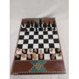 SMALL HAND-CRAFTED WOODEN CHESS-SET. VERY INTRICATE INLAID WOOD. NEEDS SOME REPAIR.