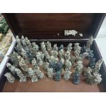 LARGE WOODEN BOX CONTAINING VERY ORNATE VINTAGE CHESS PIECES.