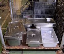 Various catering equipment steel trays with lids, racks