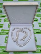 Pearl necklace with gemstone embellishments in box