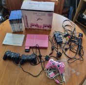 Pink playstation 2 with cables, 3 controllers, instructions, 8 games