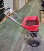 Hand operated push salt spreader