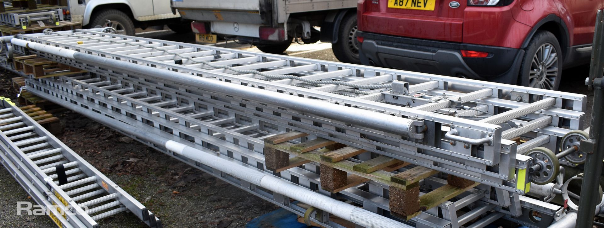 Ex - Fire & Rescue rope-operated triple extension ladder with stabilising support poles - Image 2 of 5