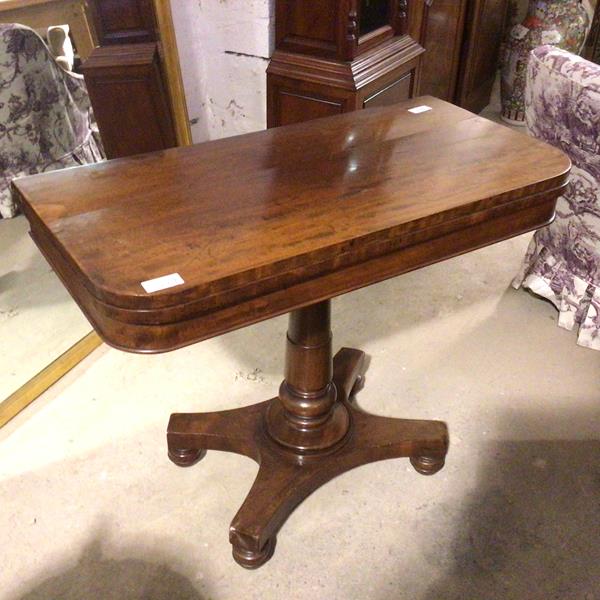 An 1830s/40s mahogany card table, the swivel top and baize interior, on turned pillar support and