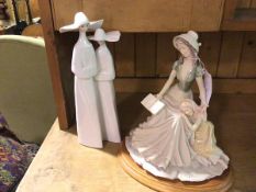 A Spanish Lladro style porcelain figure, Two Nuns (35cm) and a composition figure group, Reading