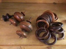 A group of wooden curtain rings (each internal d.7.5cm) and two fruitwood finials and a single