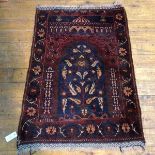 A North West Persian prayer rug with central mirab within a foliate border (110cm x 80cm)