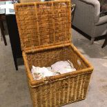 A modern wicker hinged basket, with a quantity of linens (58cm x 70cm x 56cm)