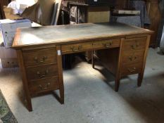 An Edwardian mahogany pedestal desk, with leather writing surface above a single frieze drawer,