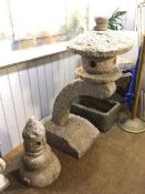 A Japanese granite pagoda garden feature, on arched support with associated garden statuary (2) (