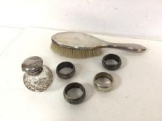 A set of four Birmingham silver napkin rings (56g) and a Birmingham silver backed hairbrush and a