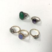A collection of rings including three 9ct gold rings, including a cluster ring with central green