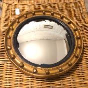 An Edwardian convex circular mirror, with gilt dished and beaded frame, inscribed 227 D verso (