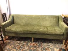 A large contemporary sofa, in olive green upholstery with single buttoned seat cushion, on