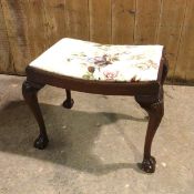 A reproduction Georgian style footstool, with floral upholstered padded top, on cabriole supports