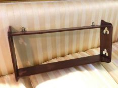 An Arts & Crafts style teak wall shelf , fitted two shelves, with trefoil detail to side supports (