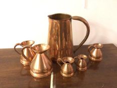 A large copper water jug (28cm), a set of measures including a pint, half pint, a half gill, a