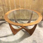 A G Plan teak circular coffee table on four curved supports, with glass central top (45cm x 84cm x